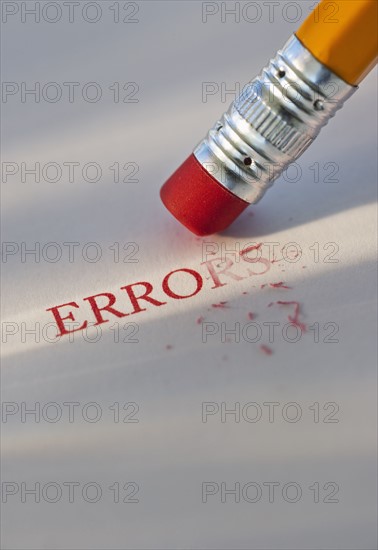 Studio shot of pencil erasing the word errors from piece of paper. Photo: Daniel Grill