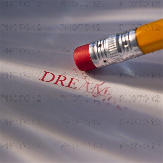 Studio shot of pencil erasing the word dream from piece of paper. Photo : Daniel Grill