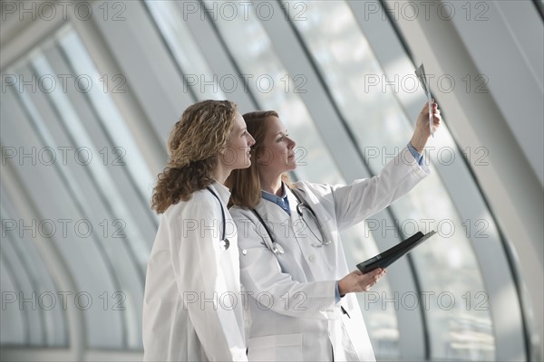 Two doctors examining x-ray. Photo : Mark Edward Atkinson