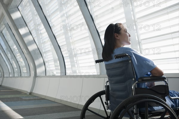 Patient in wheelchair looking out window. Photo : Mark Edward Atkinson