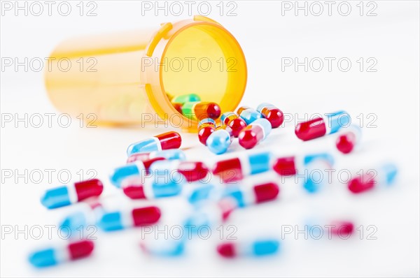 Studio shot of capsules spilling from bottle. Photo : Antonio M. Rosario