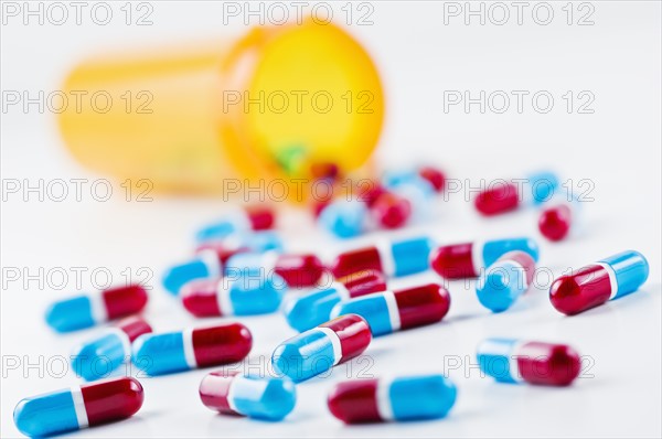 Studio shot of capsules spilling from bottle. Photo : Antonio M. Rosario