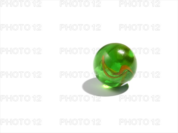 Studio shot of small green glass ball. Photo : David Arky