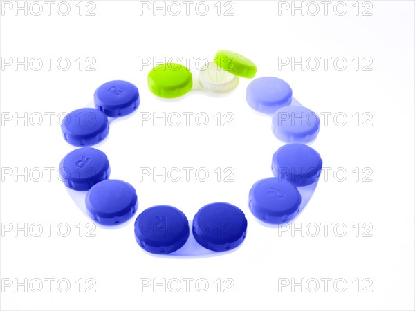 Blue and green contact lens cases on white background. Photo : David Arky