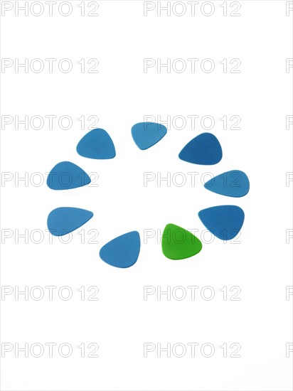 Blue and green plectrums on white background. Photo : David Arky