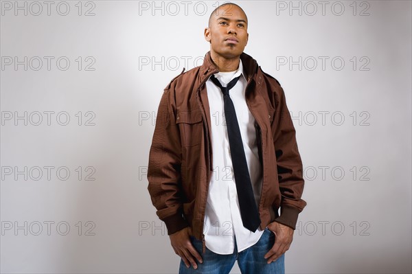 Studio portrait of young man wearing jacket. Photo : Noah Clayton