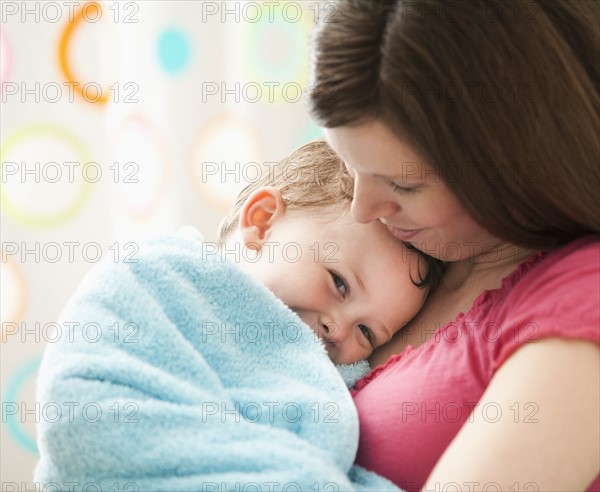 Mother with son (2-3) wrapped in towel. Photo : Mike Kemp