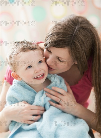 Mother with son (2-3) wrapped in towel. Photo : Mike Kemp