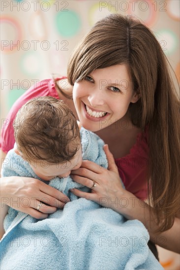 Mother with son (2-3) wrapped in towel. Photo : Mike Kemp