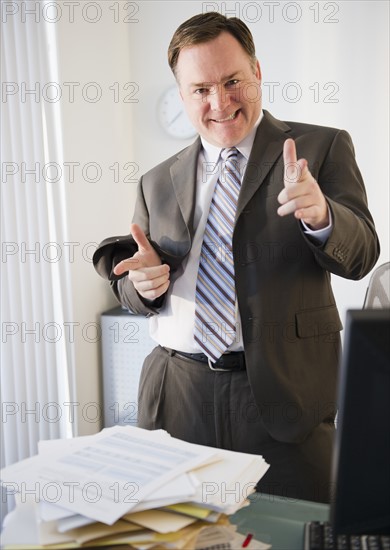 Businessman pointing to camera. Photo : Jamie Grill Photography