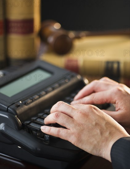 Court stenographer using stenograph machine. Photo : Daniel Grill