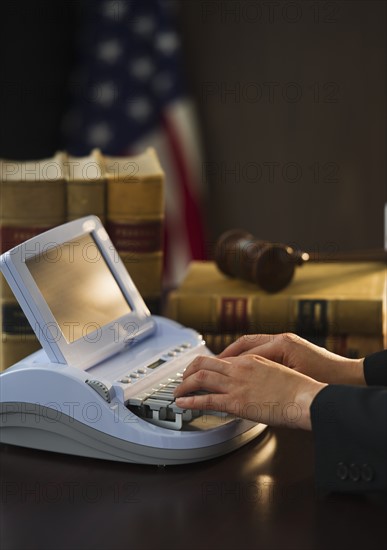 Court stenographer using stenograph machine. Photo : Daniel Grill