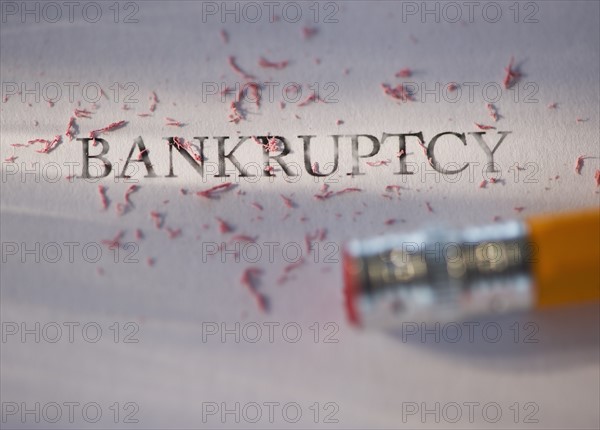 Studio shot of pencil erasing the word bankruptcy from piece of paper. Photo : Daniel Grill