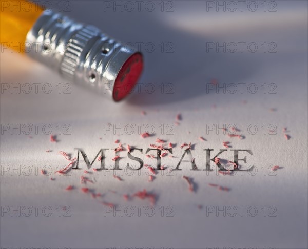 Studio shot of pencil erasing the word mistake from piece of paper. Photo: Daniel Grill