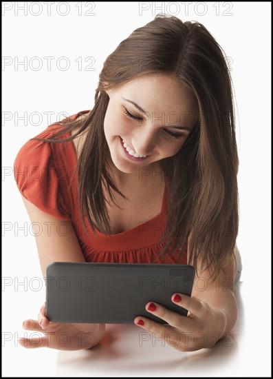 Young woman using electronic organizer. Photo: Mike Kemp