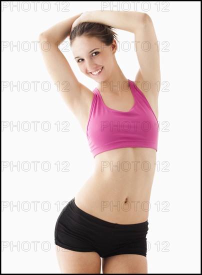 Studio portrait of young woman smiling. Photo : Mike Kemp