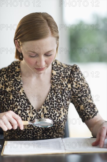 Woman examining documents.