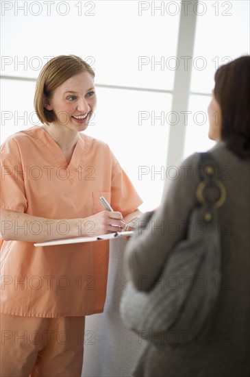 Female nurse talking with patient.