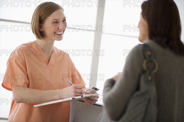 Female nurse talking with patient.