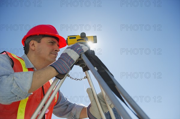 Construction worker against blue sky.