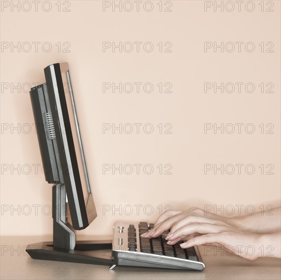 Studio shot of woman working on computer.