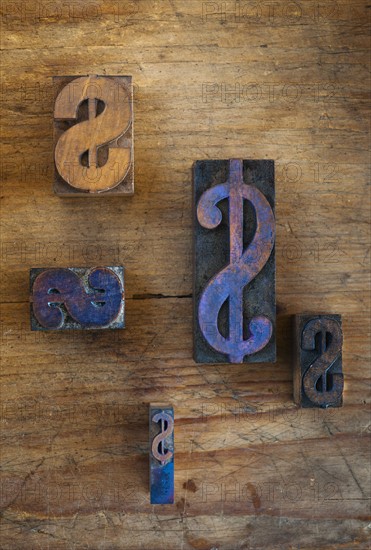 Close up of printing blocks with dollar sign on wood.
