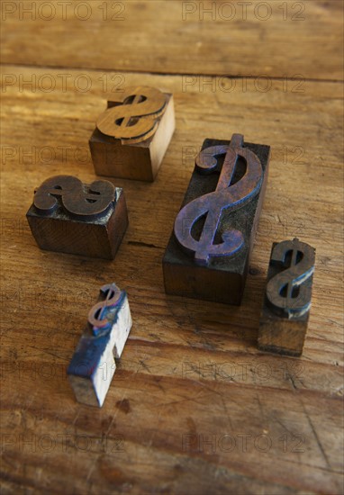 Close up of printing blocks with dollar sign on wood.