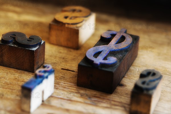 Close up of printing blocks with dollar sign on wood.