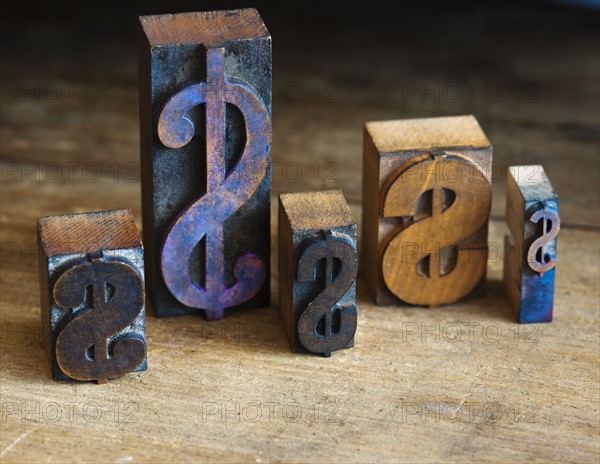 Close up of printing blocks with dollar sign on wood.