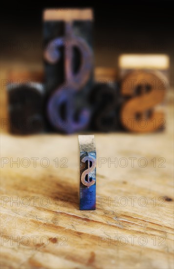 Close up of printing blocks with dollar sign with defocused background.