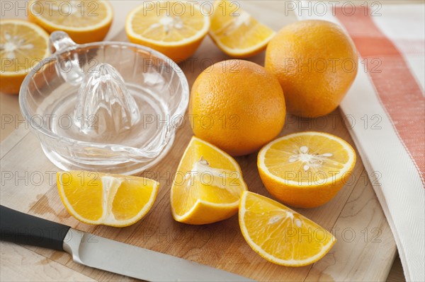 Sliced oranges on chopping board.