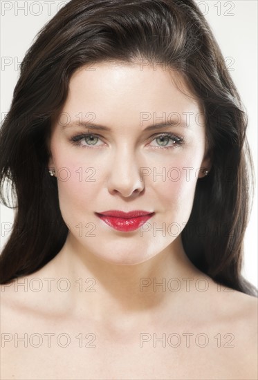 Portrait of young woman wearing red lipstick.