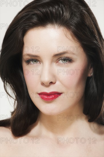 Portrait of young woman wearing red lipstick.