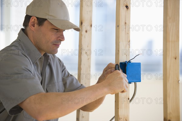 Electrician working at construction site.