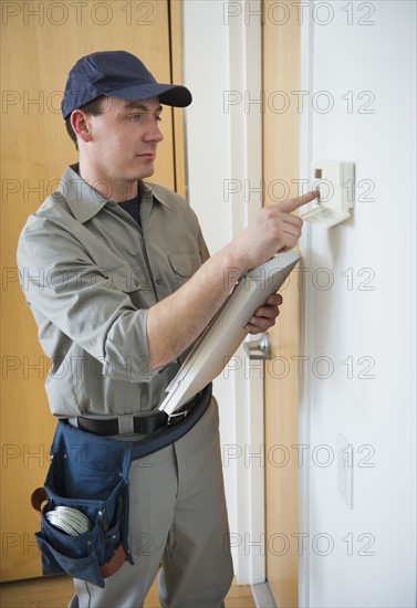 Worker repairing security system.