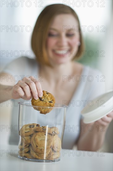 Woman eating cookies.