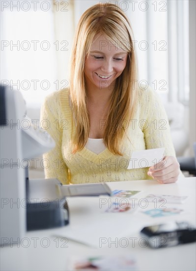 Woman looking at photographs. Photo: Jamie Grill Photography