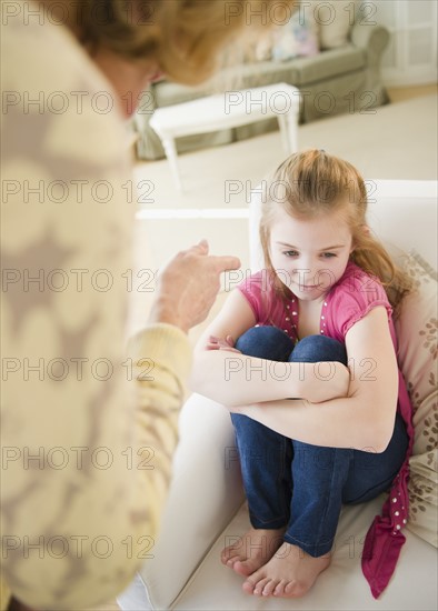 Mother scolding daughter (10-11). Photo : Jamie Grill Photography