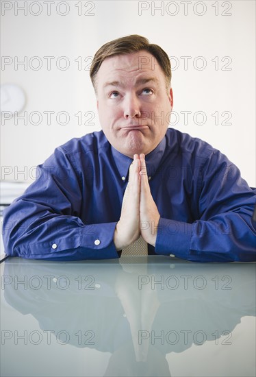 Businessman praying. Photo: Jamie Grill Photography