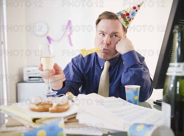 Businessman at office party. Photo: Jamie Grill Photography