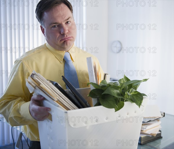 Businessman moving office. Photo : Jamie Grill Photography