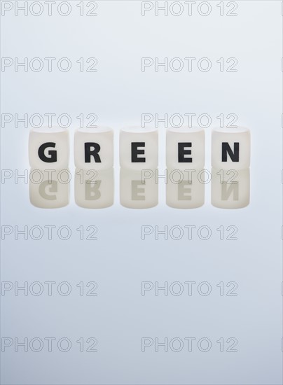 Studio shot of dice spelling out green. Photo : Daniel Grill