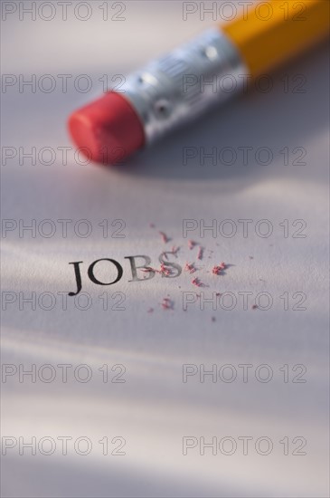 Studio shot of pencil erasing the word jobs from piece of paper. Photo : Daniel Grill