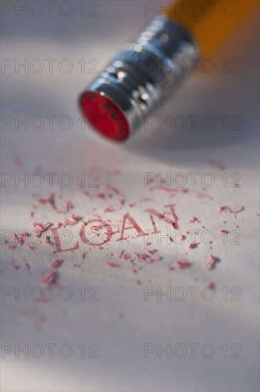 Studio shot of pencil erasing the word loan from piece of paper. Photo: Daniel Grill