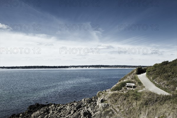 France, Brittany, Finistere Department, Bench, coastline and ocean. Photo : Jon Boyes