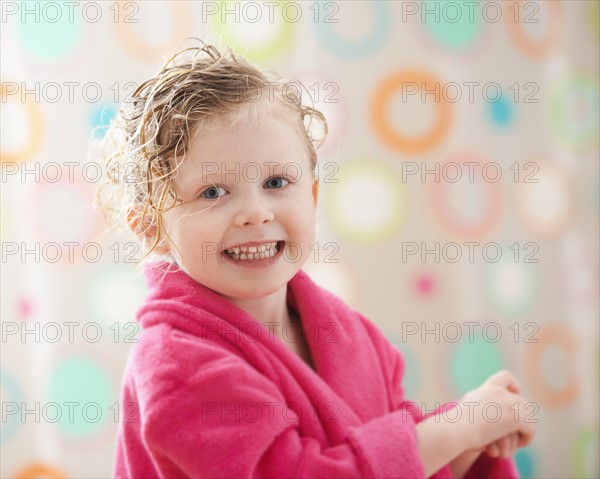 Portrait of girl (2-3) wrapped in bathrobe. Photo: Mike Kemp