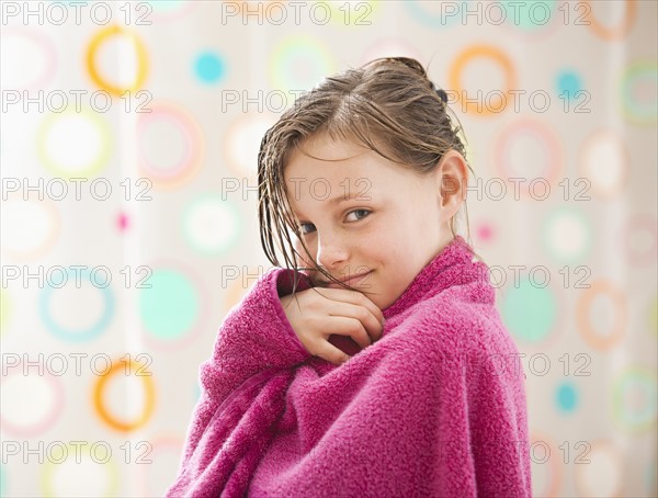 Portrait of girl (10-11) wrapped in towel. Photo : Mike Kemp