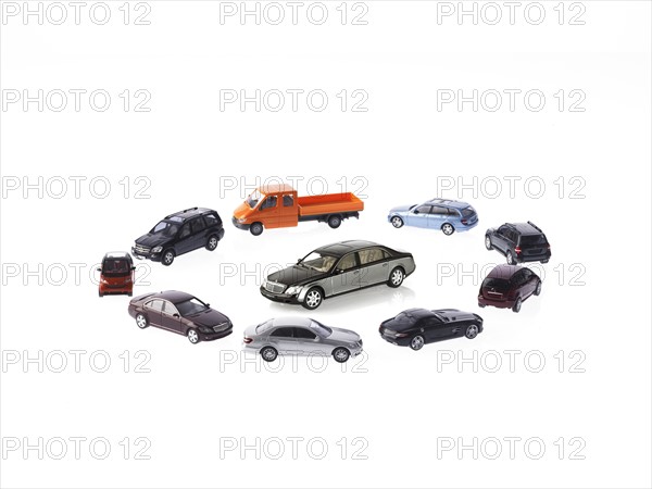 Circle of different cars on white background. Photo : David Arky