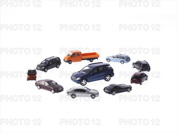 Circle of different cars on white background. Photo : David Arky