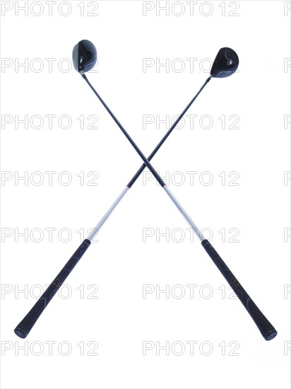 Two golf clubs on white background. Photo: David Arky